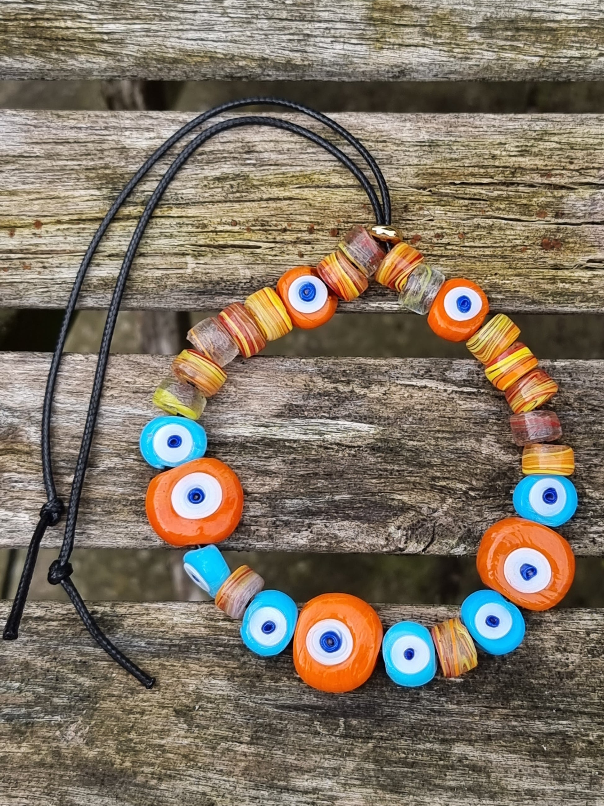 Necklace with colorful beads on a wooden surface