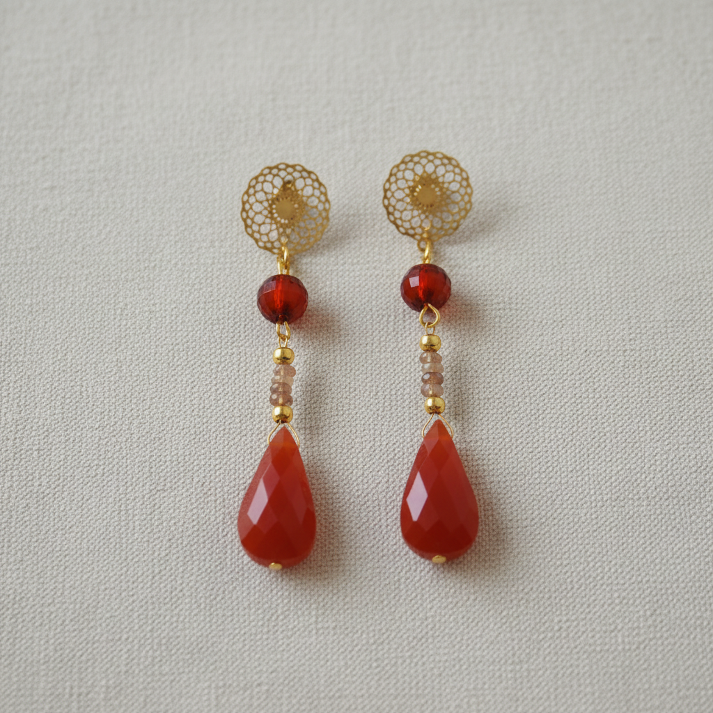 Flat lay of red chalcedony and ametrine filigree earrings